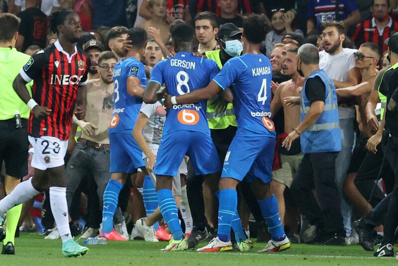 Fans try to invade the pitch during the French L1 match between Nice and Marseille at the Allianz Riviera stadium in Nice. AFP
