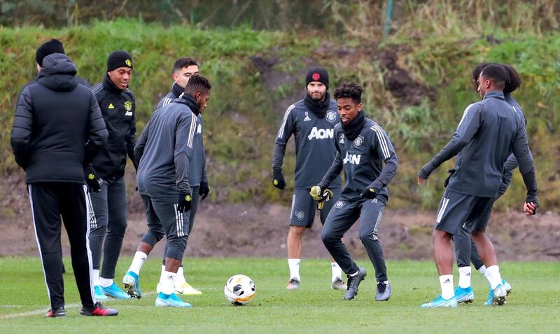 Manchester United players take part in training.