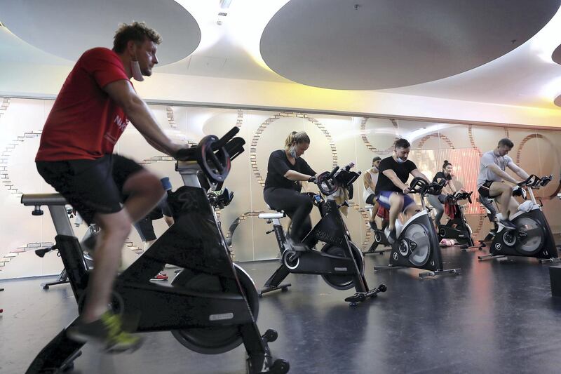 DUBAI, UNITED ARAB EMIRATES , August 10 – 2020 :- Participants during the cycling session at the UFC Gym in Murjan 6 in Jumeirah Beach Residence in Dubai. They are taking part in the 90 minutes MMA Mash up. (Pawan Singh / The National) For News/Online/Instagram. Story by Nick Webster