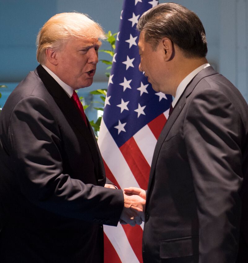 US President Donald Trump and Chinese President Xi Jinping, right, shake hands as they arrive for a meeting on the sidelines of the G20 summit
