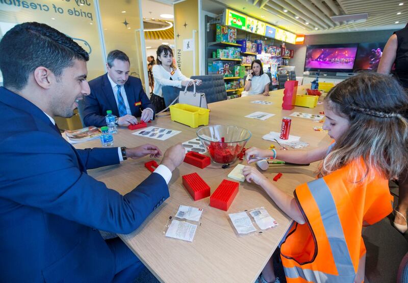 DUBAI, UNITED ARAB EMIRATES - Visitors building their own Lego design at the opening of the new Lego office in Dubai Design District.  Leslie Pableo for The National