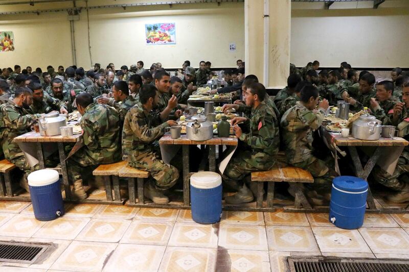 Soldiers of Afghan National Army break the Ramadan fast at their military base in Herat, western Afghanistan. EPA