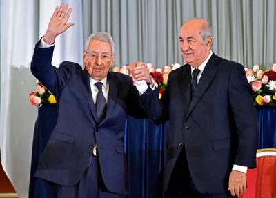 Algerian President-elect Abdelmadjid Tebboune (R) and interim president Abdelkader Bensalah wave during the formal swearing-in ceremony in the capital Algiers on December 19, 2019. The 74-year-old Tebboune, a former prime minister seen as close to the country's powerful military chief, reportedly garnered 58.13 percent of votes in the first ballot of a highly contested presidential election, according to the announced final results. He said after his victory he was ready for dialogue with a months-long protest movement that toppled his predecessor Abdelaziz Bouteflika. / AFP / RYAD KRAMDI                        
