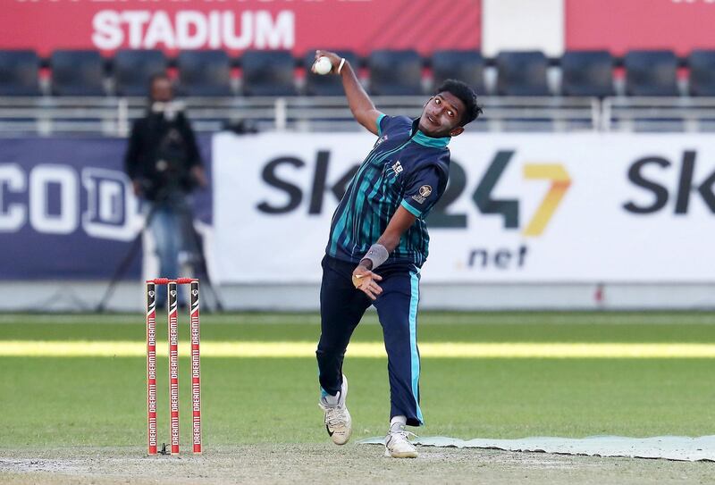 DUBAI, UNITED ARAB EMIRATES , December 15 – 2020 :- Karthik Meiyappan of ECB team bowling during the Emirates D20 cricket tournament between ECB vs Sharjah held at Dubai International Cricket Stadium in Dubai. ECB won the match by 64 runs. ( Pawan Singh / The National ) For Sports/Stock. Story by Paul