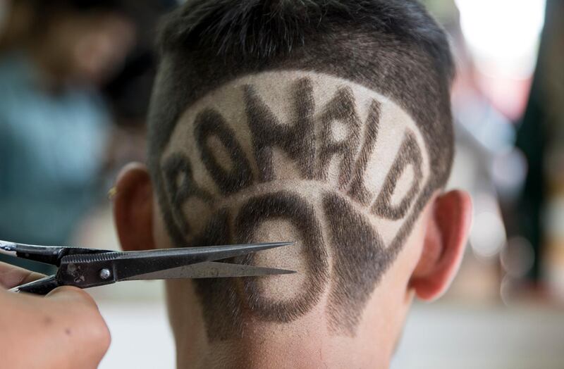 Nepalese youngster Jeevan Giri, 19, has the name of Portuguese footballer Cristiano Ronaldo cut into his hair at a barber shop in Kathmandu, Nepal. Naremdra Shrestha / EPA