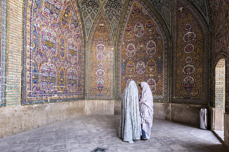 Iranian young women talk on a yard of Nasir al-Mulk Mosque, called the Pink Mosque as well, in Shiraz, Iran, September 15, 2018. (Photo by Dominika Zarzycka/NurPhoto via Getty Images)