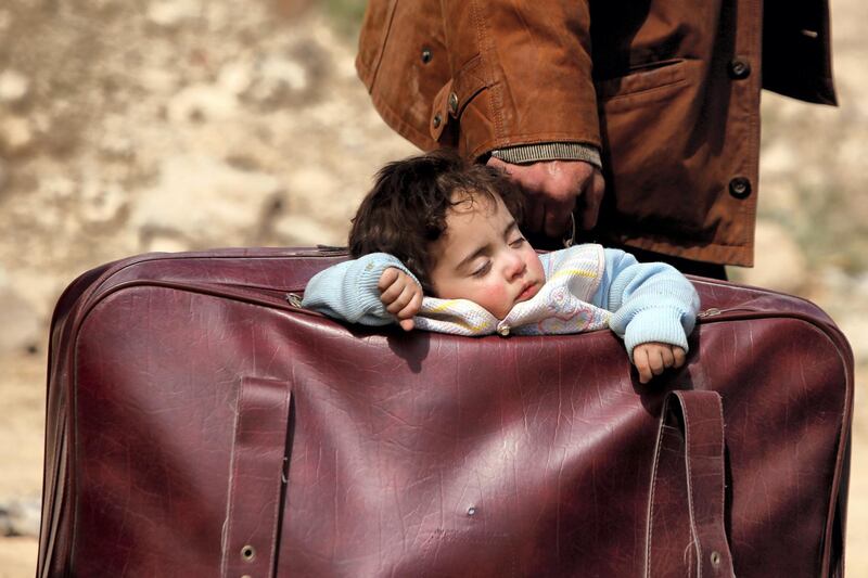 A child sleeps in a bag in the village of Beit Sawa, eastern Ghouta, Syria, March 15, 2018. Picture taken March 15, 2018. REUTERS/Omar Sanadiki/File Photo   SEARCH "POY DECADE" FOR THIS STORY. SEARCH "REUTERS POY" FOR ALL BEST OF 2019 PACKAGES. TPX IMAGES OF THE DAY.