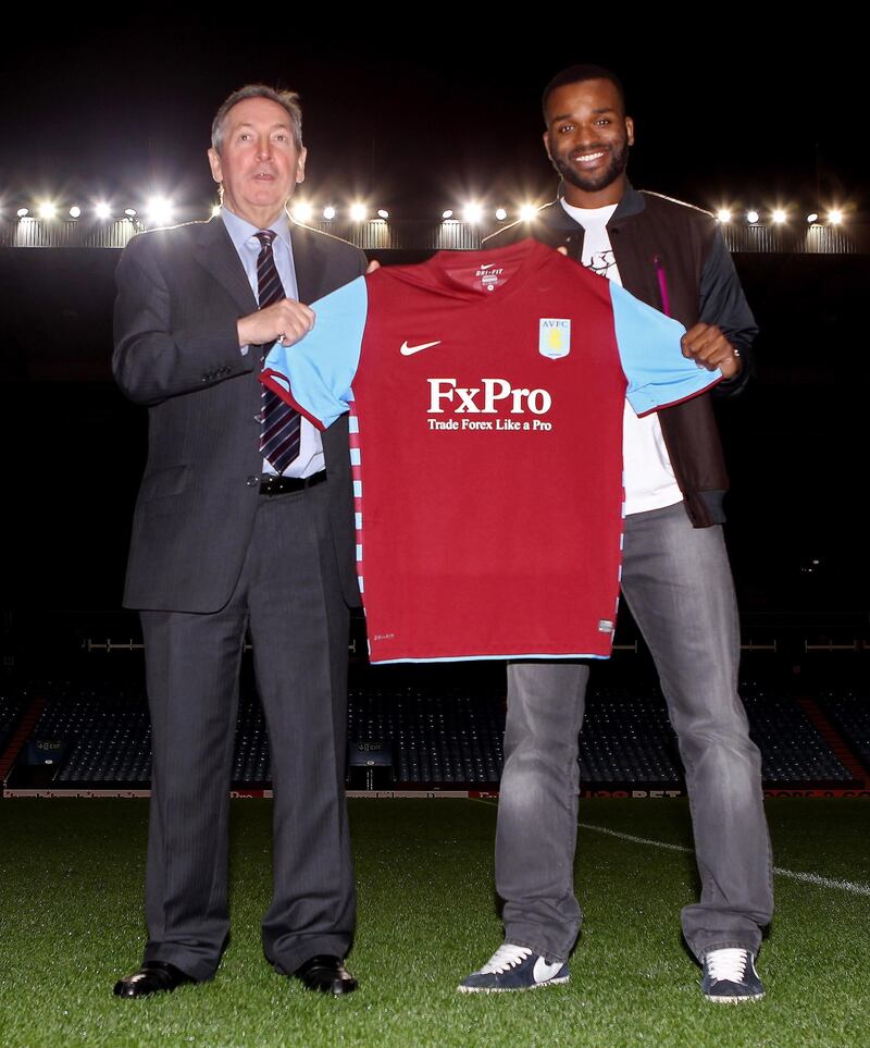 BIRMINGHAM, ENGLAND - JANUARY 18:  Darren Bent (R) and manager Gerrard Houllier hold the shirt during a press conference to announce him signing for Aston Villa at Villa Park on January 18, 2011 in Birmingham, England.  (Photo by Scott Heavey/Getty Images)