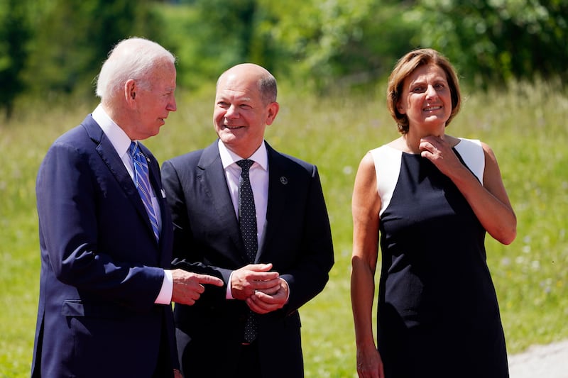 Mr Biden is welcomed by Mr Scholz and his wife Britta Ernst. AP 
