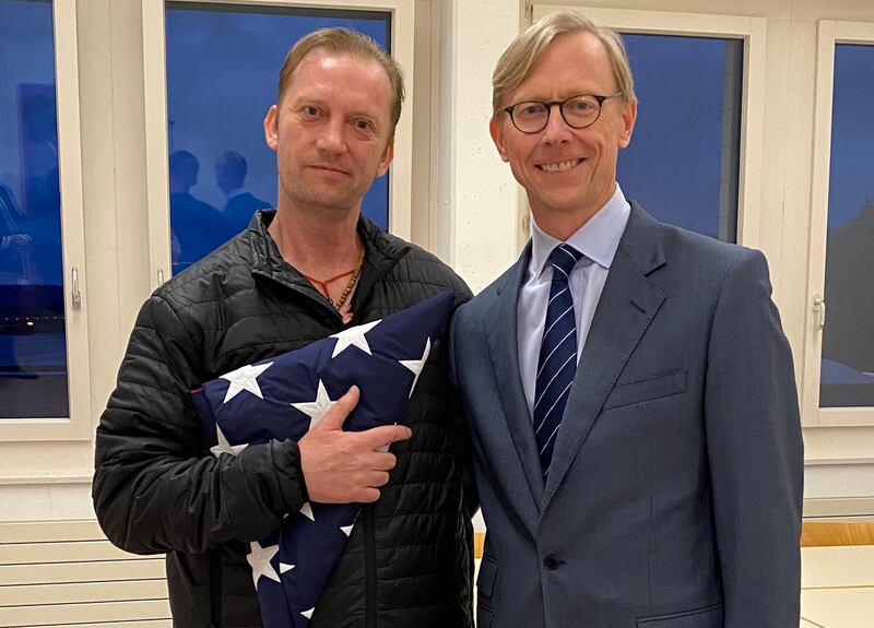 This handout photo released by the US State Department on June 4, 2020 shows US Navy veteran Michael White (L) holding a folded US flag as he poses with US Special Envoy to Iran Brian Hook at Zurich Airport in Zurich, Switzerland, on June 4, 2020, after White was released from Iran. President Donald Trump voiced hope for progress with arch-rival Iran on June 4 after the clerical regime released US Navy veteran Michael White and the United States freed two Iranians. Michael White, who had contracted the coronavirus while in Iran, flew out on a Swiss military jet to Zurich where he was welcomed by a senior US official. - RESTRICTED TO EDITORIAL USE - MANDATORY CREDIT "AFP PHOTO / US STATE DEPARTMENT " - NO MARKETING - NO ADVERTISING CAMPAIGNS - DISTRIBUTED AS A SERVICE TO CLIENTS
 / AFP / US State Department / - / RESTRICTED TO EDITORIAL USE - MANDATORY CREDIT "AFP PHOTO / US STATE DEPARTMENT " - NO MARKETING - NO ADVERTISING CAMPAIGNS - DISTRIBUTED AS A SERVICE TO CLIENTS
