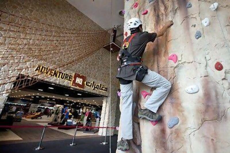 A rock climber tries out some equipment on Adventure HQ's climbing wall. The outdoors supplier caters to a number of disciplines. Jaime Puebla / The National