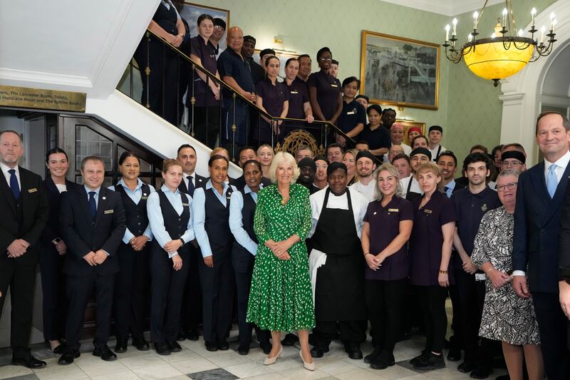 Queen Camilla with members of staff at the Royal Air Force Club. PA