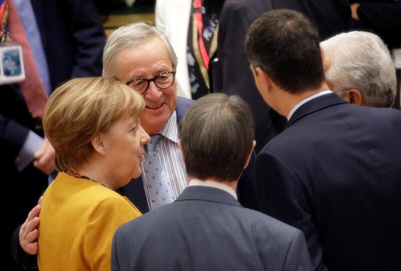 European Commission President Jean-Claude Juncker, second left, speaks with German Chancellor Angela Merkel, left, and Spanish Prime Minister Pedro Sanchez, second right, during a round table meeting at an EU summit in Brussels, Friday, March 22, 2019. European Union leaders gathered again Friday after deciding that the political crisis in Britain over Brexit poses too great a threat and that action is needed to protect the smooth running of the world's biggest trading bloc. (AP Photo/Olivier Matthys, Pool)