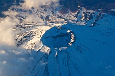The volcanic crater of a snow-capped Mount Fuji. Getty Images