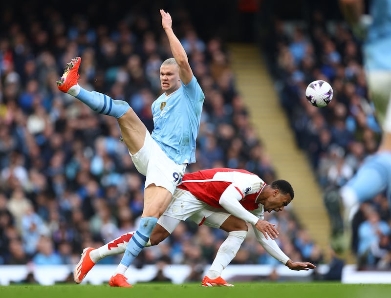Manchester City's Erling Haaland fights for the ball with Arsenal's Gabriel. Reuters