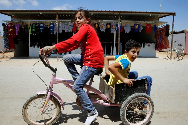 Syrian refugee children play on the main market street in the Al-Zaatari refugee camp in the Jordanian city of Mafraq, near the border with Syria, July 30, 2018. Picture taken July 30, 2018. REUTERS/Muhammad Hamed