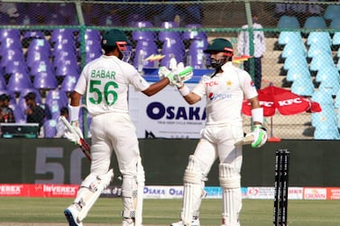 Pakistan's batsman Muhammad Rizwan (R) and Babar Azam (L) celebrate 50 run during the fifth and final day of the second Test cricket match between Pakistan and Australia at the Na?tional Cricket Stadium in Karachi, Pakistan, 16 March 2022.   EPA / REHAN KHAN