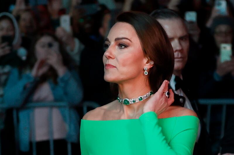 Kate, Princess of Wales, wears a bright green off-the-shoulder gown from Solace London with an emerald choker and matching earrings that belonged to Princess Diana