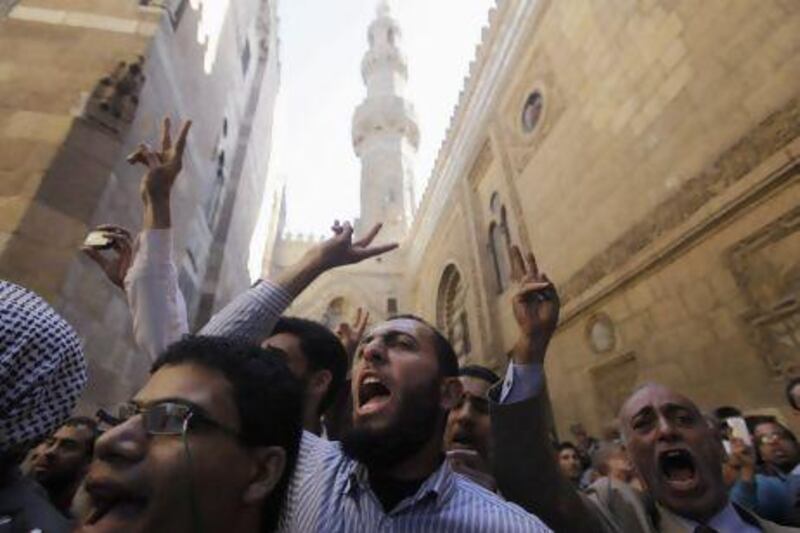 Supporters of Egyptian President Mohamed Morsi and members of the Muslim Brotherhood shout slogans during the funerals of people who died in recent clashes at the presidential palace according to local media, at Al Azhar mosque in Cairo on December 7. The crisis unleashed by Morsi's bid to wrap up Egypt's transition on his own terms has eroded his nation's faith in their nascent democracy and will complicate the already unenviable task of government.