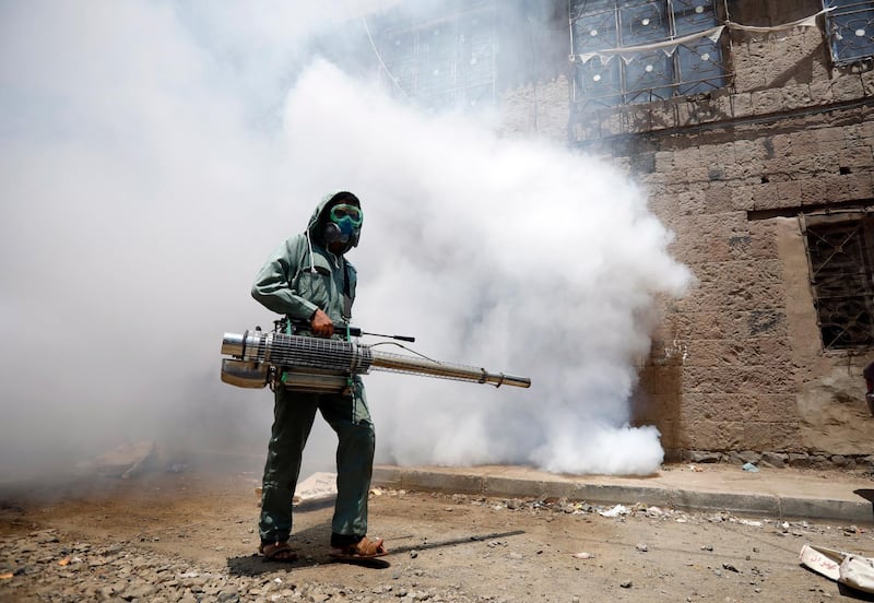 A Yemeni worker fumigates a neighbourhood as a precaution against the spread of the coronavirus Covid-19. EPA
