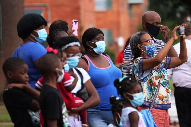 People watch and record as John Lewis's casket is taken into Brown Chapel Church in Selma, Alabama. AFP