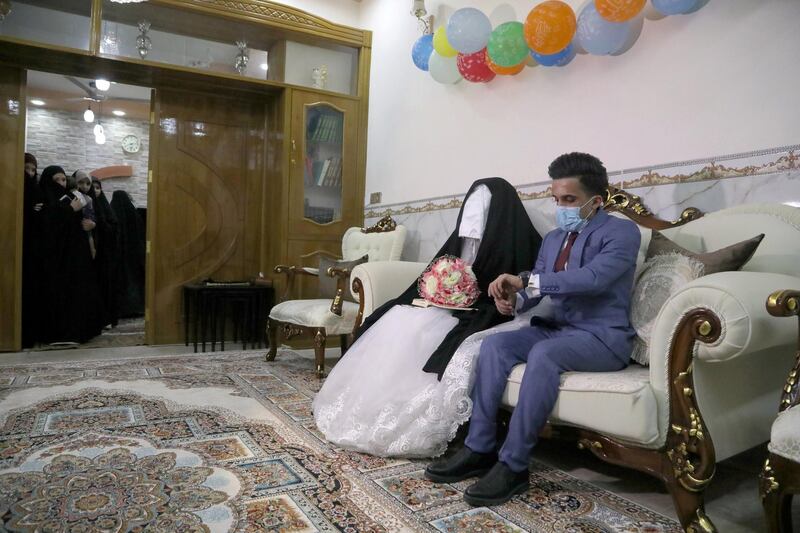 An Iraqi couple is seen at their wedding during a curfew imposed to prevent the spread of coronavirus disease (COVID-19), in the holy city of Kerbala, Iraq. REUTERS