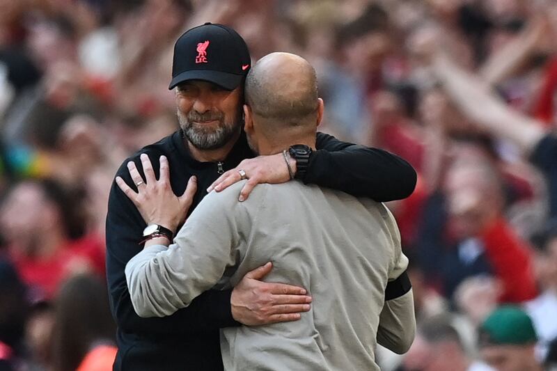 Liverpool manager Jurgen Klopp and Manchester City's Pep Guardiola embrace at the end of the game. AFP