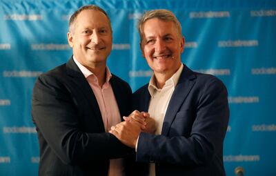 epa06960151 PepsiCo CEO Ramon Laguarta (R) and CEO of SodaStream, Daniel Birnbaum (L), shake hands while posing during a joint news conference in Tel Aviv, Israel, 20 August 2018. Reports on 20 August 2018 state U.S. softdrink giant PepsiCo has confirmed it will buy Sodastream for 3.2 billion US dollars. Sodastream is listed by the US stock exchange NASDAQ. Daniel Birnbaum, the current CEO of Sodastream, reportedly will continue to lead the company.  EPA/ABIR SULTAN