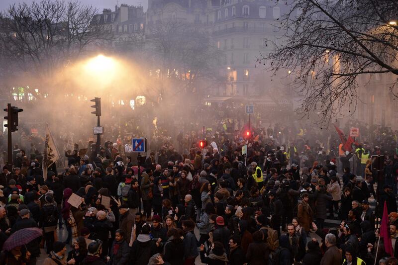 Protesters demonstrate at Nation in Paris, on December 17, 2019 during a nation-wide protest against the French government's plan to overhaul the country's retirement system. Hundreds of thousands of protesters hit French streets on December 17 in a pension reform standoff that has sparked nearly two weeks of crippling transport strikes, with the government vowing it will not give in to union demands to drop the overhaul. / AFP / Aurore MESENGE

