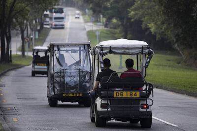 Golf carts travel along a road in Discovery Bay, a residential project developed by Hong Kong Resort Co., on Lantau Island in Hong Kong, China, on Tuesday, March 27, 2018. As carmakers race to sell glitzy new models to wealthy Chinese, the old-fashioned golf cart is the hottest buy in one corner of Hong Kong, with prices topping those of a Tesla Model S and Porsche's Boxster sports cars. Photographer: Justin Chin/Bloomberg