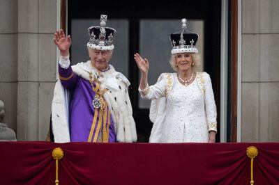 King Charles III and Queen Camilla wave from the Buckingham Palace balcony during the coronation celebrations. Getty