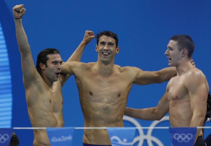 (from R) USA’s Ryan Murphy, Cody Miller, Michael Phelps celebrate after the men’s swimming 4x100m medley relay final at the Rio 2016 Olympic Games at the Olympic Aquatics Stadium in Rio de Janeiro on August 13, 2016. Odd Andersen / AFP