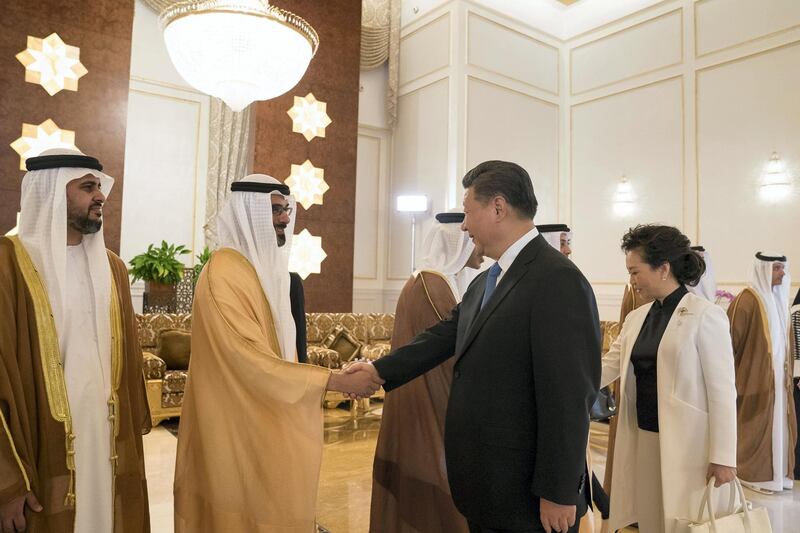 ABU DHABI, UNITED ARAB EMIRATES - July 19, 2018: HH Major General Sheikh Khaled bin Mohamed bin Zayed Al Nahyan, Deputy National Security Adviser (2nd L) greets HE Xi Jinping, President of China (R), during a reception held at the Presidential Airport. Seen with HH Sheikh Theyab bin Mohamed bin Zayed Al Nahyan, Chairman of the Department of Transport, and Abu Dhabi Executive Council Member (L) and Peng Liyuan, First Lady of China (back R).
( Mohamed Al Hammadi / Crown Prince Court - Abu Dhabi )
---