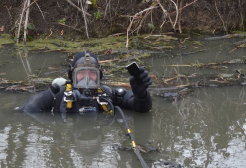 A police diver recovers a mobile phone belonging to Sarah Everard from a canal in Sandwich, Kent. PA