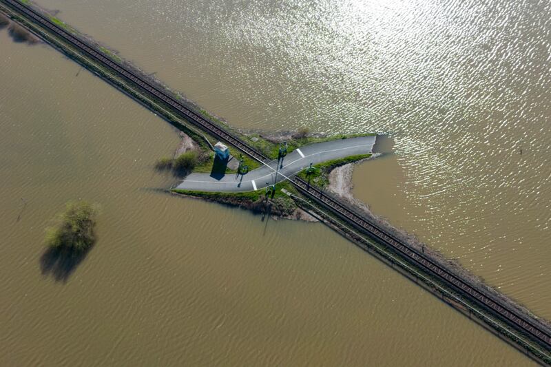 A railroad crossing lies in the middle of a flooded meadow in Nidderau, Germany. AP