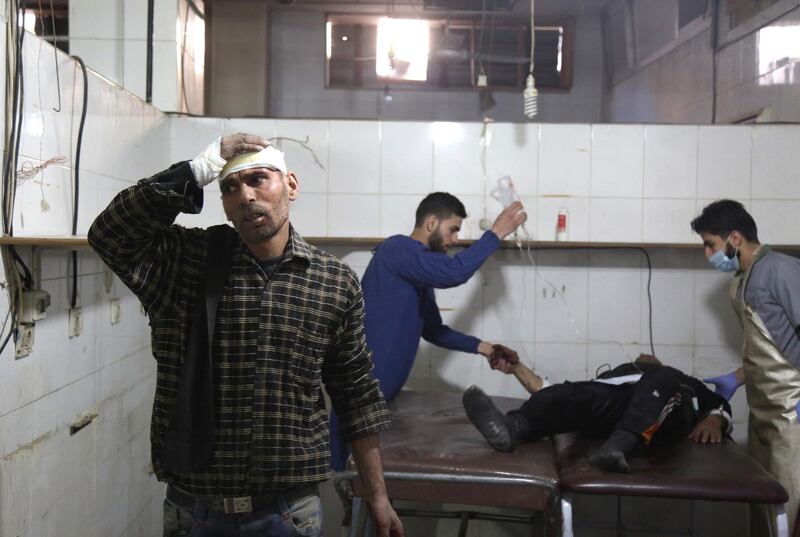 Syrian paramedics give medical aid to a victim at a make-shift hospital in Kafr Batna following government air strikes on the town of Jisreen, in the besieged Eastern Ghouta region on the outskirts of the capital Damascus, on February 19, 2018. Ammar Suleiman / AFP