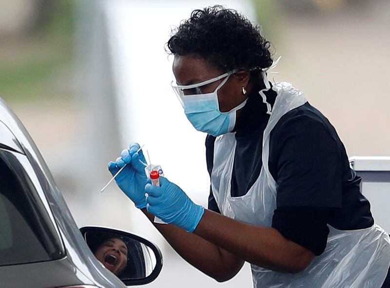 Medical staff at an NHS drive through coronavirus disease (COVID-19) testing facility in the car park of Chessington World of Adventures, as the spread of the coronavirus disease (COVID-19) continues, Chessington, Britain, March 30, 2020. REUTERS/Peter Nicholls