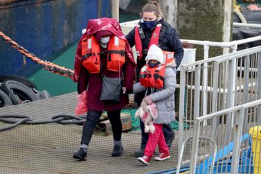 People thought to be migrants are brought into port by British Border Force officers. AP