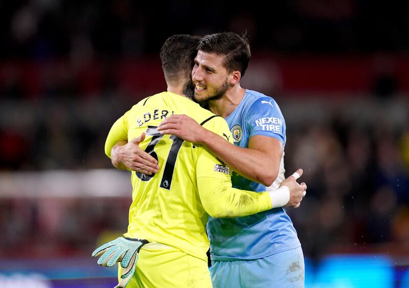 Manchester City goalkeeper Ederson hugs Ruben Dias at the end of the match at the Brentford Community Stadium. PA