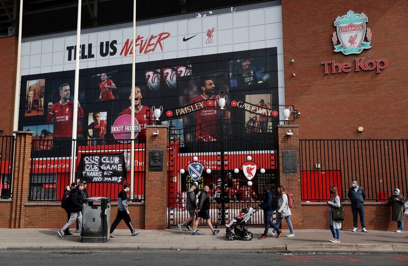 Liverpool fans walk past a banner during the protest at Anfield. Reuters