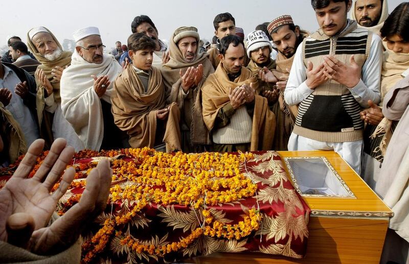 Pakistani villagers offer prayers during the funeral of a victim killed in an attack on Bacha Khan University in Charsadda on January 21, 2016. Mohammad Sajjad/AP Photo