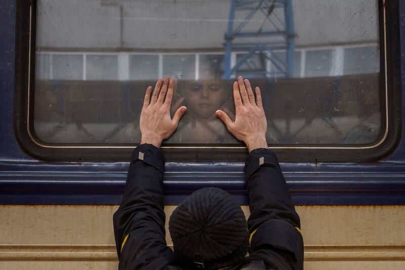 Aleksander, 41, says goodbye to his daughter Anna, 5, at Kyiv station, Ukraine. AP Photo / Emilio Morenatti
