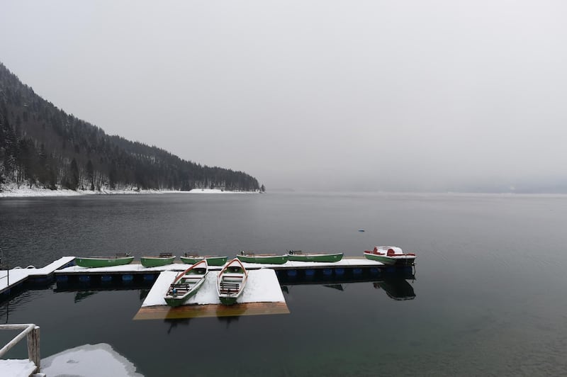 Sightseeing boats are placed on a snow-covered landing stage, at Lake Walchensee, southern Germany. Andreas Gebert / dpa via AP