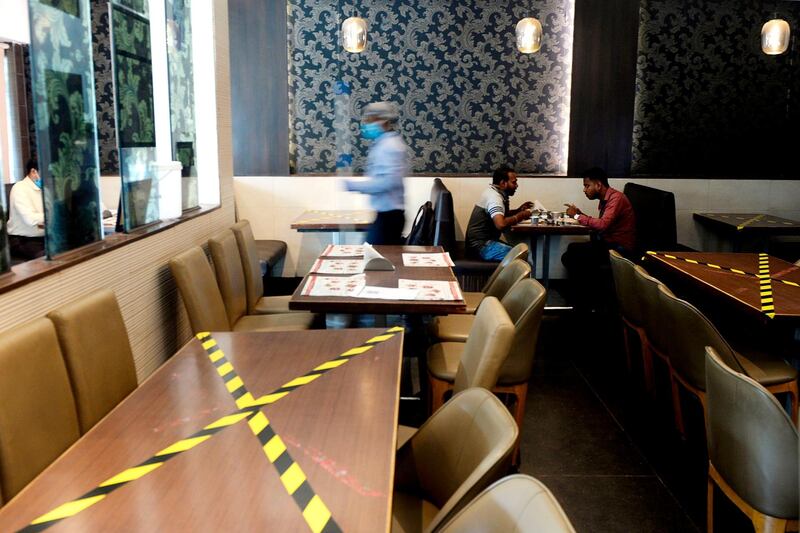 People maintain social distancing at a restaurant in Chennai, India.  AFP