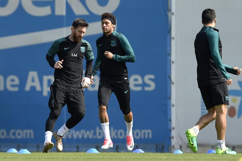 Lionel Messi, Neymar and Uruguayan Luis Suarez take part in a drill. Lluis Gene / AFP