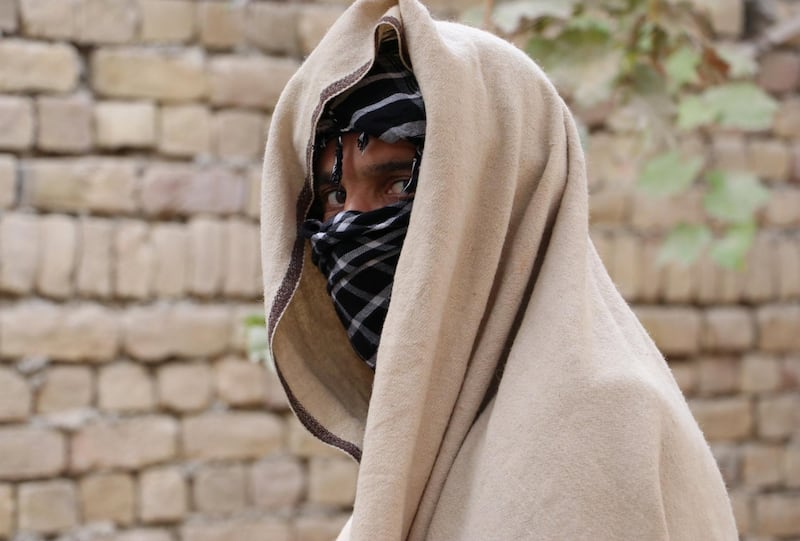 Nineteen-year-old Taliban deserter hides his face in Kunduz province, Afghanistan. Reuters