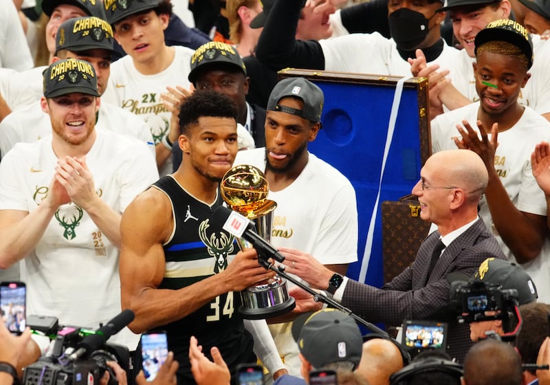 Milwaukee Bucks forward Giannis Antetokounmpo accepts the Bill Russell NBA Finals Most Valuable Player Award from NBA commissioner Adam Silver.