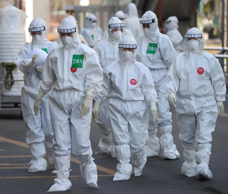 Medical professionals wearing protective gear are seen walking to a ward at Dongsan Hospital in Daegu, the epicenter of the coronavirus outbreak in South Korea.  EPA