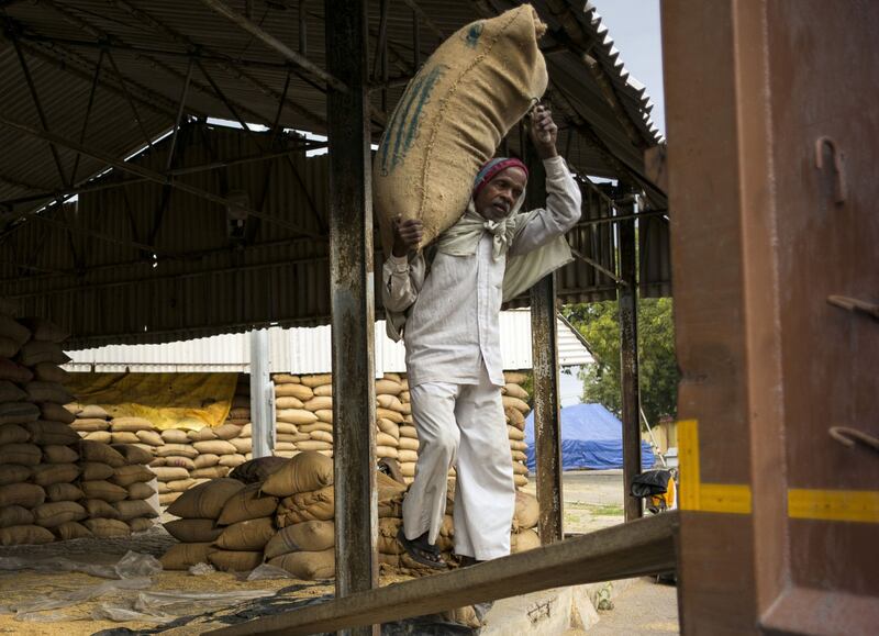 A worker carries a sack of rice at a wholesale grain market in Uttar Pradesh, India. Rice is the latest commodity to get swept up in the Russia-Ukraine conflict. Bloomberg