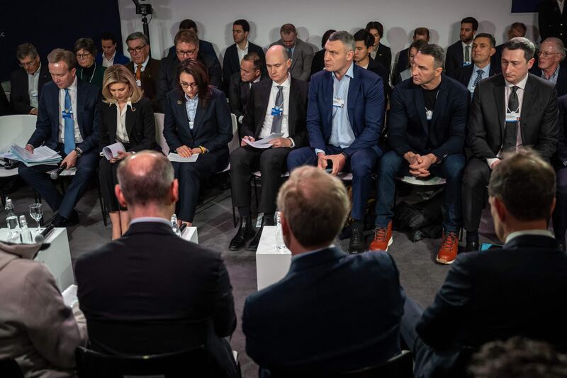 Ukraine's First Lady Olena Zelenska, Kyiv mayor Vitali Klitschko and Wladimir Klitschko observe a moment of silence during the World Economic Forum in Davos, Switzerland. AFP